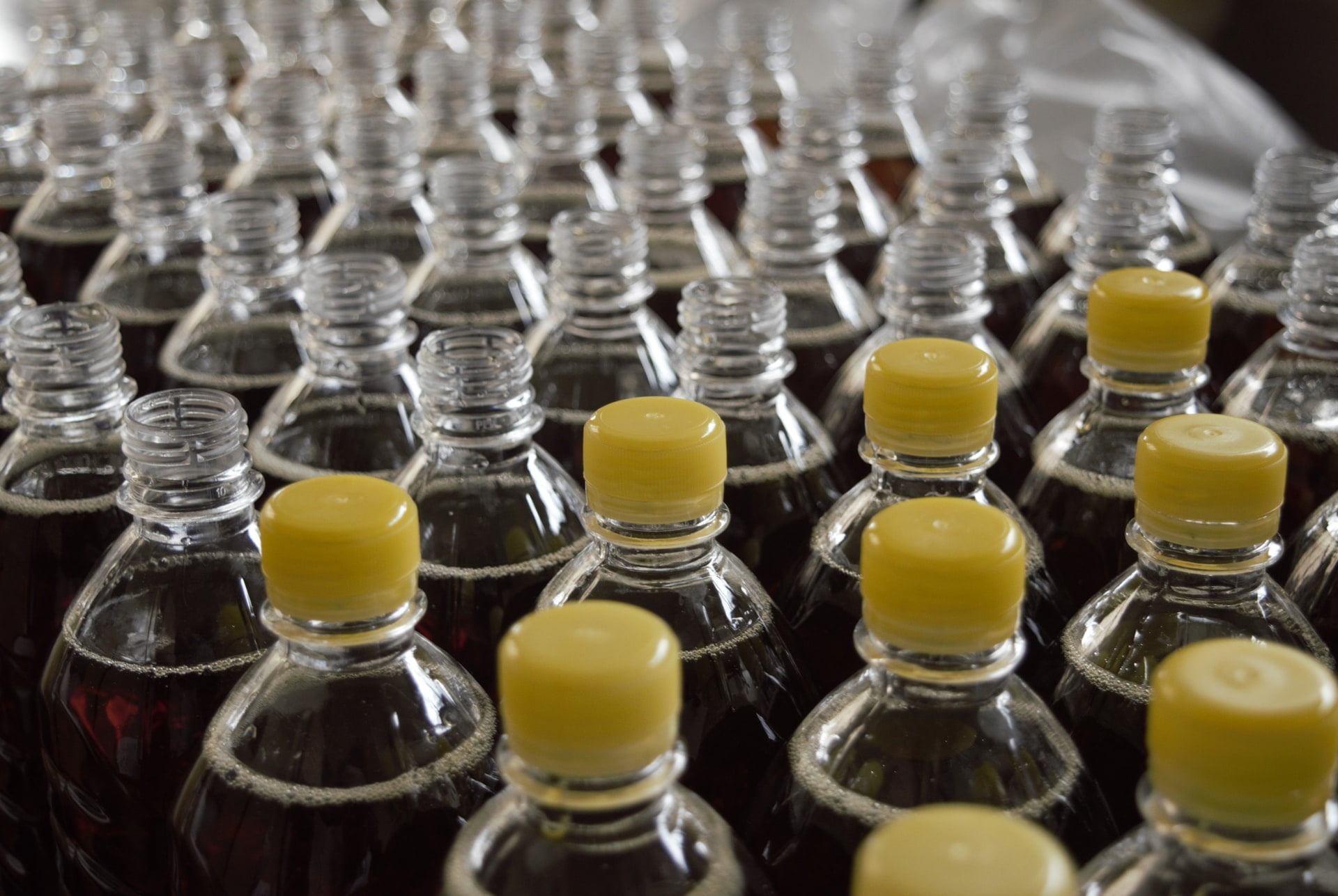 plastic bottles filled with liquid some with caps on