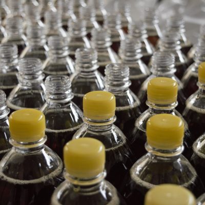 plastic bottles filled with liquid some with caps on