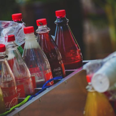 Multiple bottles with red labels and lids